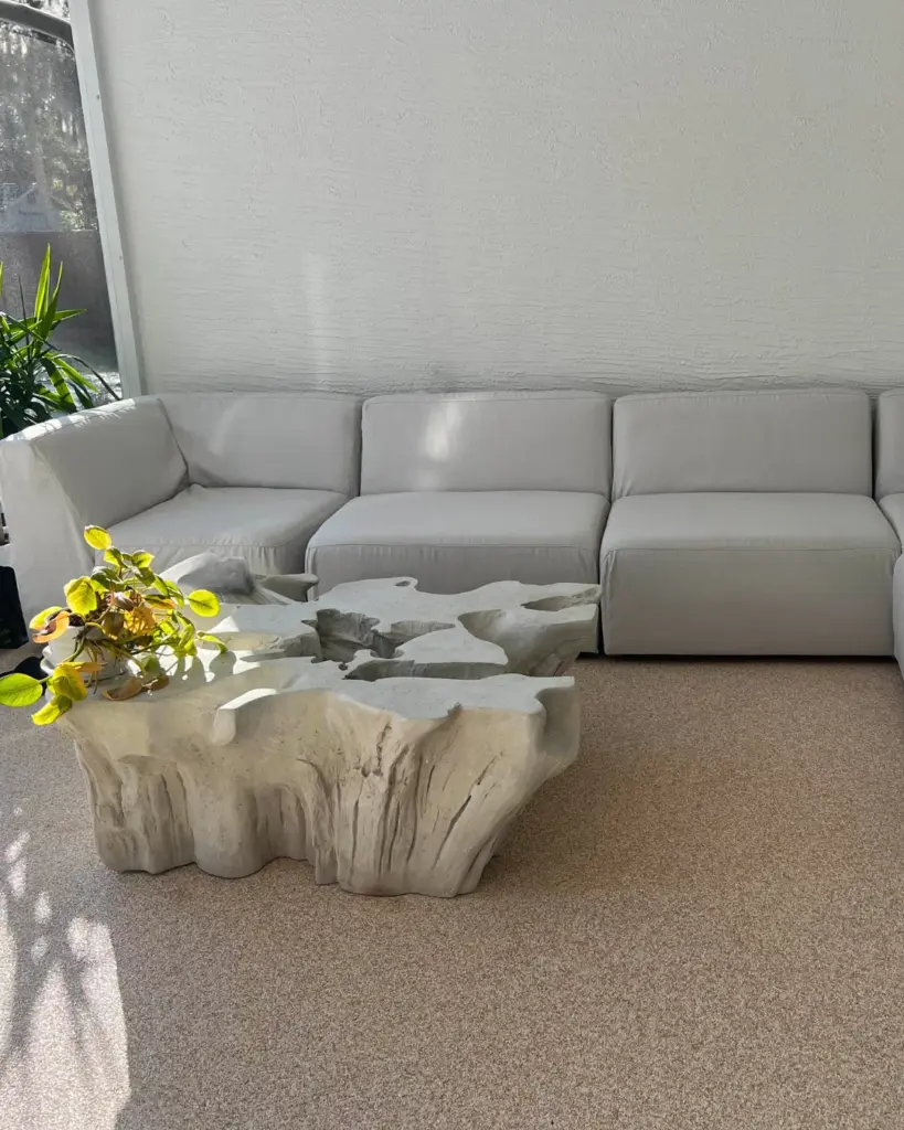 Finished light interior floor beside a white sofa and wooden coffee table.