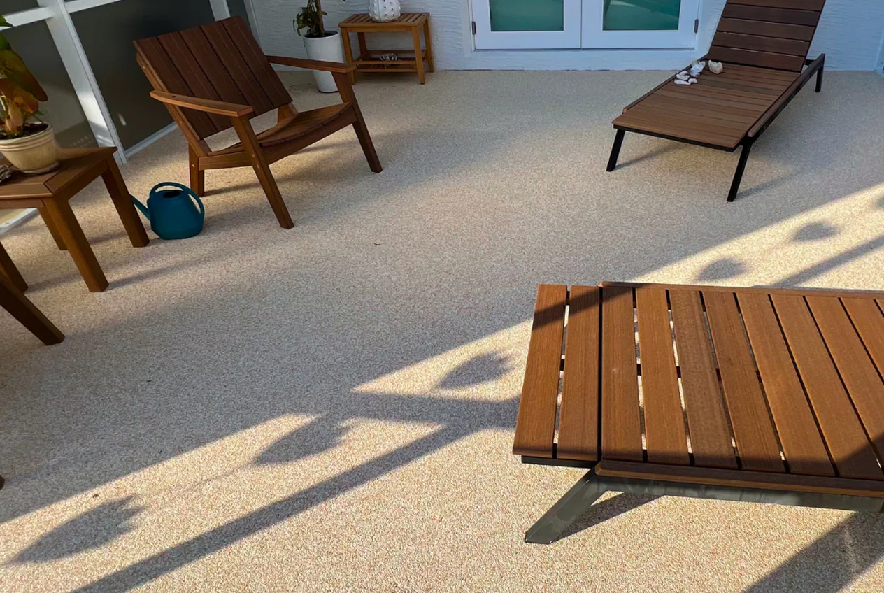 Screened patio with loungers on a warm speckled resurfaced floor