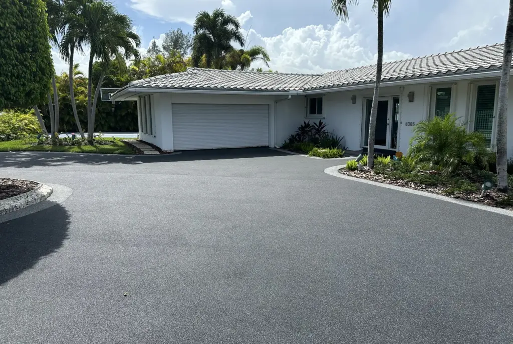 Wide resurfaced driveway sweeping up to a single-storey home