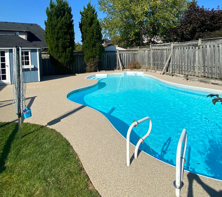 Pool deck after coating with a tan rubber surface and a clean edge