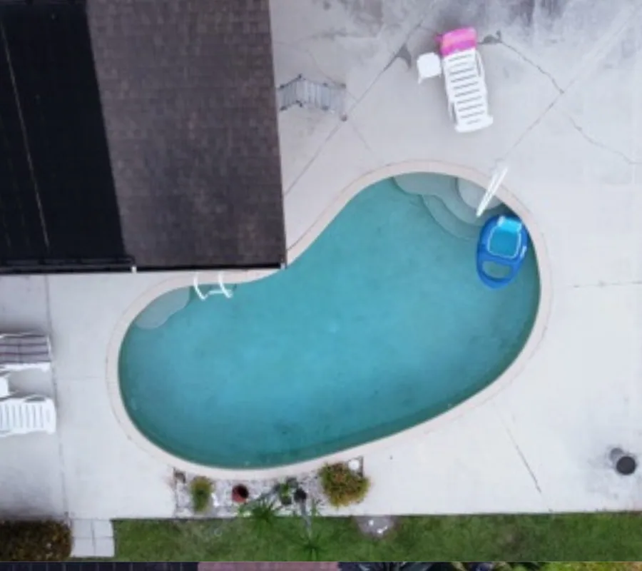 Aerial view of a pool patio before resurfacing