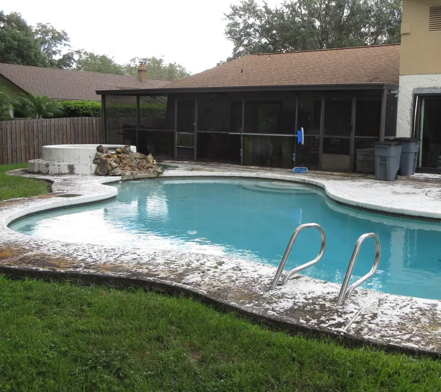 Pool deck before an upgrade: stained edge and aged concrete