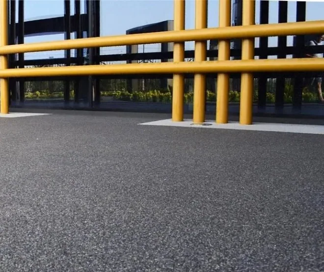 Dark quartz natural stone surface in a commercial entryway with yellow safety rails.