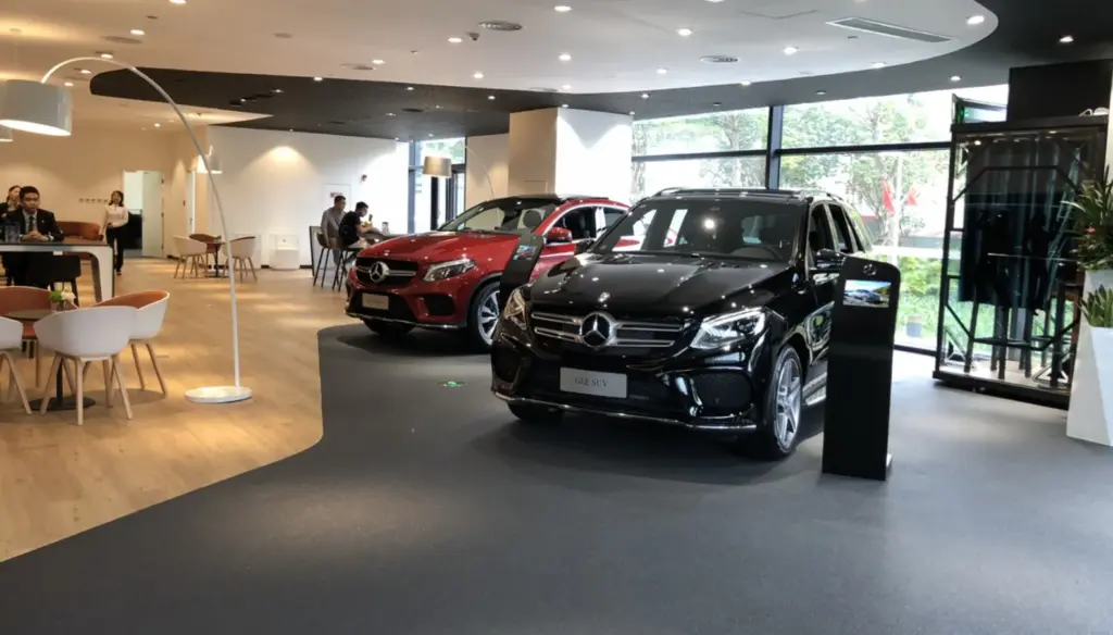 Quartz natural stone floor in an indoor showroom with luxury cars on display.